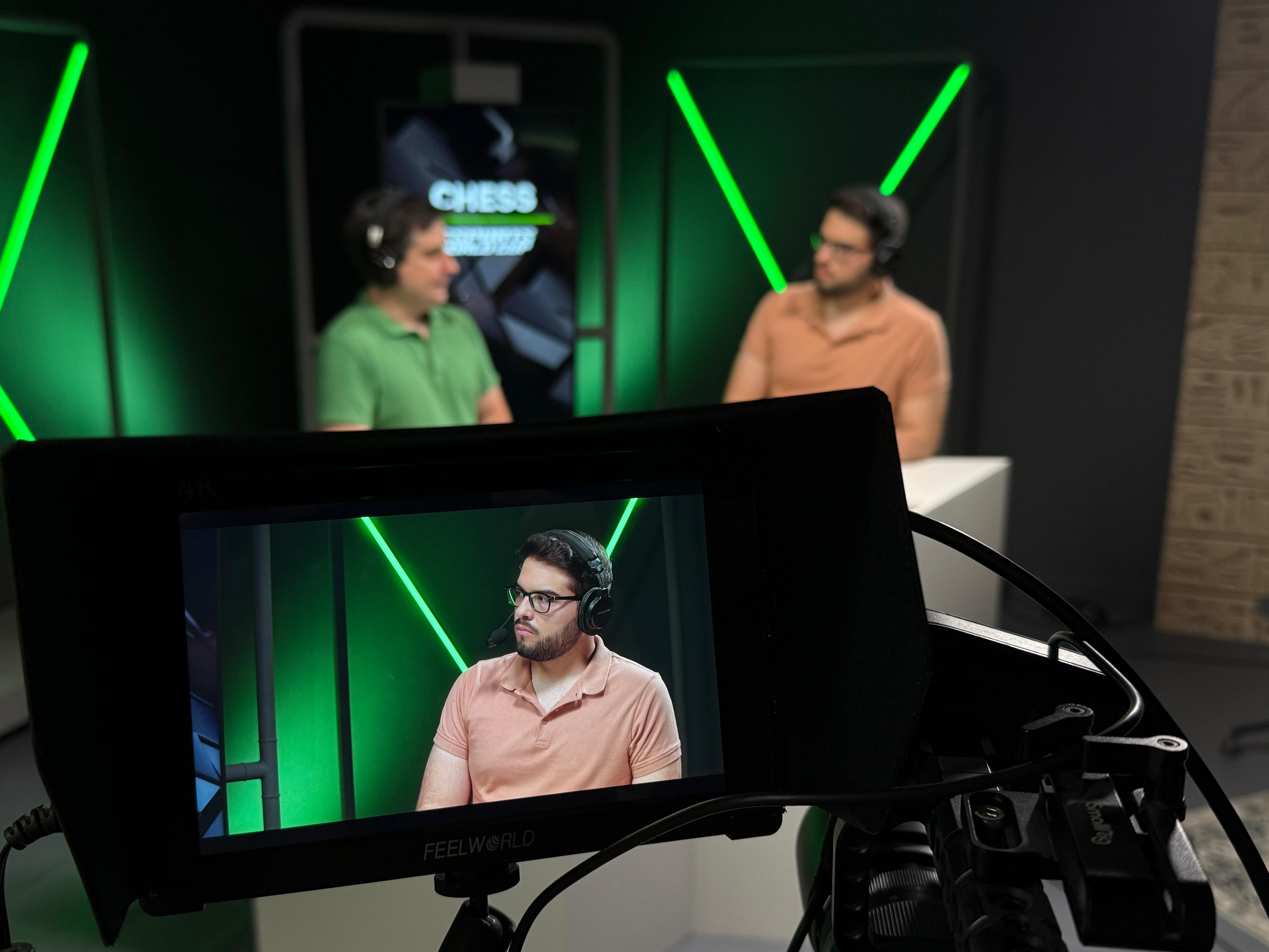 Camera monitor showing João Guilherme Matos commentating on a live chess broadcast